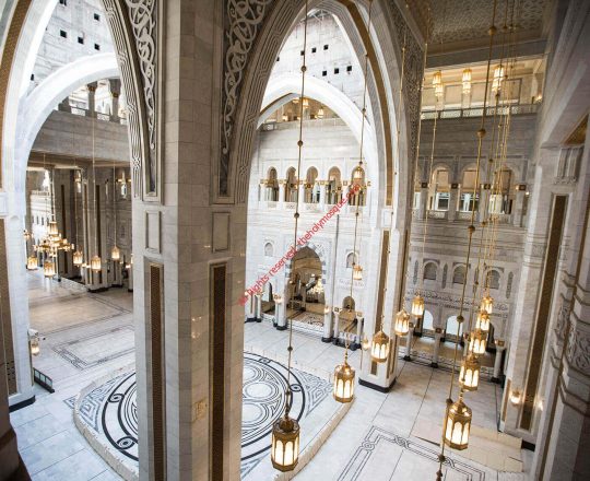 تظهر في الصورة أعمدة منتصف التوسعة السعودية الثالثة يعلوها القبة الرئيسية المتحركة يكسو جدرانها اغلى أنواع الرخام كما تتدلى الثريات من اسقفها وتظهر قاعات الصلاة على الجونب ويتميز المدخل الرئيسي برسومات عربية على ارضيتها . وتختفي داخل الاعمدة فتحات التكييف والسماعات يكسوها أنماط واشكال عربية نحاسية. 